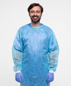 A person wearing blue disposable surgical gown